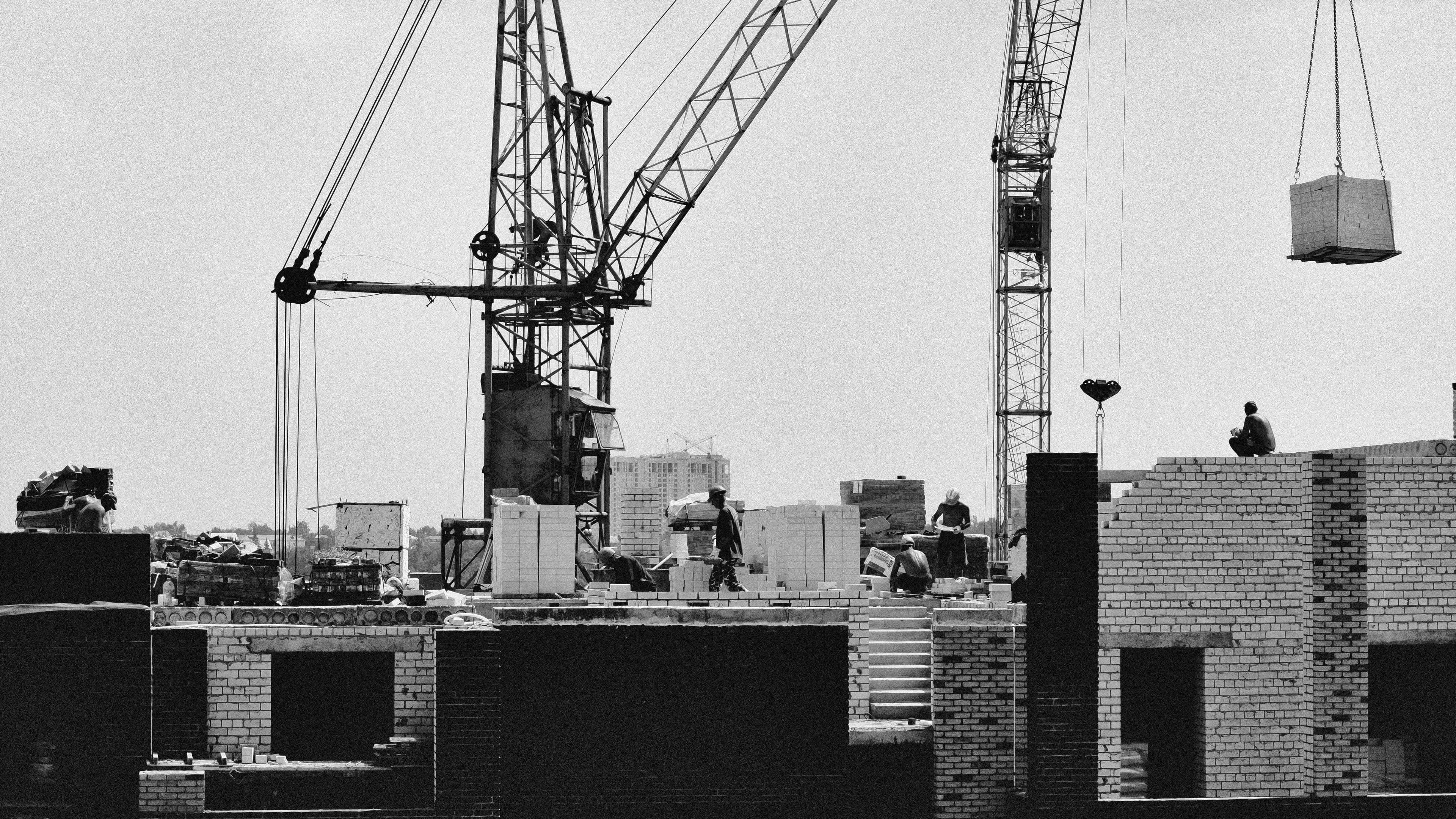 Modern construction site with cONStrAct delivery truck showcasing professional building materials procurement